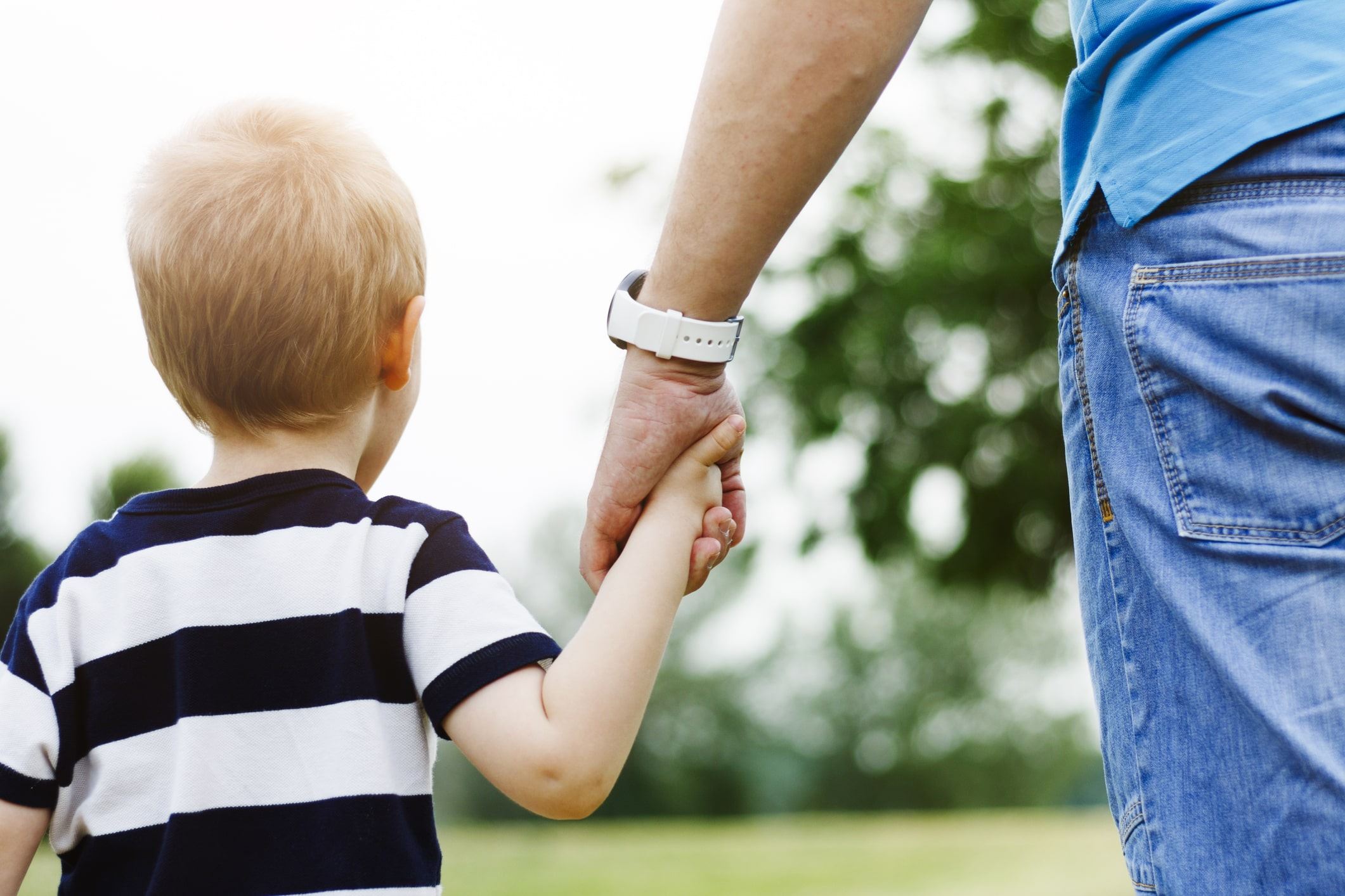 father and son holding hands